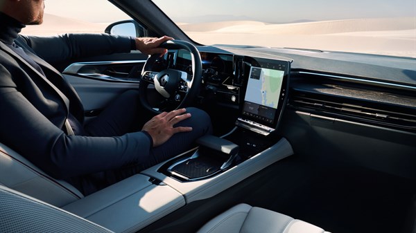 A man driving his Renault car using the integrated driver assistance technologies